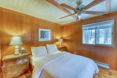 a bedroom with a bed and a ceiling fan at Mount Snow Chalet in West Dover