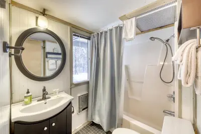 a bathroom with a sink and a toilet and a mirror at Mount Snow Chalet in West Dover