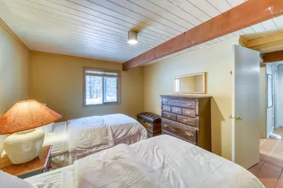 a bedroom with two beds and a dresser at Mount Snow Chalet in West Dover