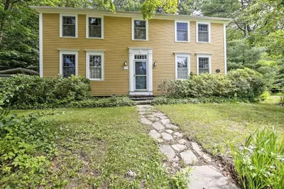 a yellow house with a stone path in front of it at Historic Huntington Home - Walk to Westfield River in Huntington