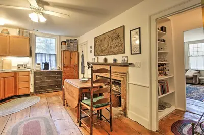a kitchen with a desk and a fireplace at Historic Huntington Home - Walk to Westfield River in Huntington