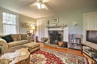 a living room with a couch and a fireplace at Historic Huntington Home - Walk to Westfield River in Huntington