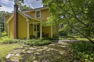 a yellow house with a yard in front of it at Historic Huntington Home - Walk to Westfield River in Huntington