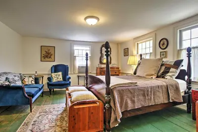 a bedroom with a bed and a table and chairs at Historic Huntington Home - Walk to Westfield River in Huntington
