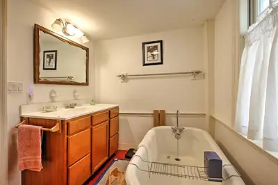 a bathroom with a tub and a sink at Historic Huntington Home - Walk to Westfield River in Huntington