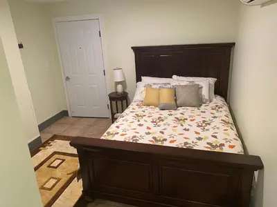 a bedroom with a bed with a wooden headboard at Cold Spring Hotel in Cold Spring