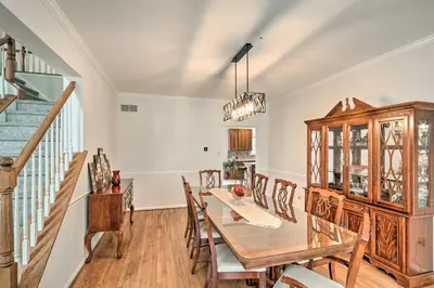 a dining room with a table and chairs and a staircase at Blue Mtn Lake Family House, Steps to Beach! in East Stroudsburg
