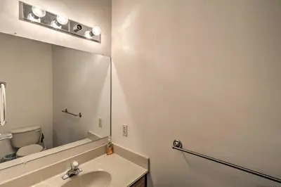 a white bathroom with a sink and a mirror at Blue Mtn Lake Family House, Steps to Beach! in East Stroudsburg
