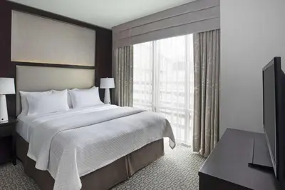 a bedroom with a large bed and a large window at Cambria Hotel White Plains - Downtown in White Plains
