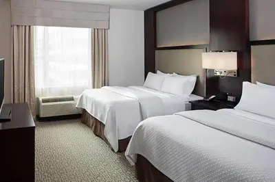 a hotel room with two beds and a window at Cambria Hotel White Plains - Downtown in White Plains