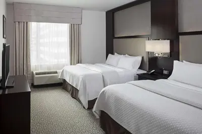 a hotel room with two beds and a window at Cambria Hotel White Plains - Downtown in White Plains