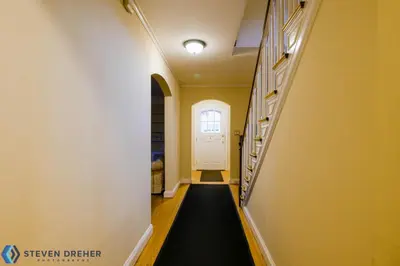 a hallway with a white door and a black floor at Town Plot Waterbury in Waterbury