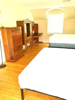 a bedroom with a bed and a dresser at Town Plot Waterbury in Waterbury