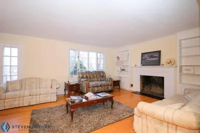 a living room with two couches and a fireplace at Town Plot Waterbury in Waterbury