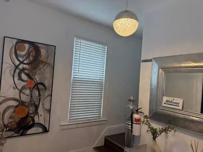 a bathroom with a mirror and a window and a lamp at Cozy Private bedrooms Kitchen Wifi in Englewood
