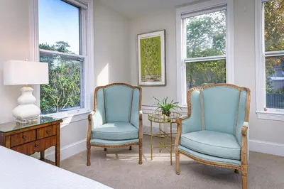 two chairs and a table in a room with windows at The West Lane Inn in Ridgefield