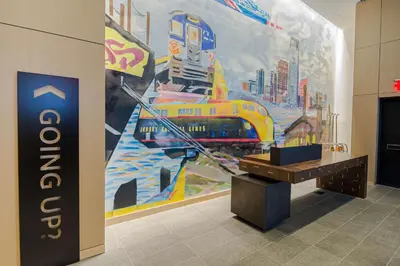 a room with a mural of a train on the wall at Canopy By Hilton Jersey City Arts District in Jersey City