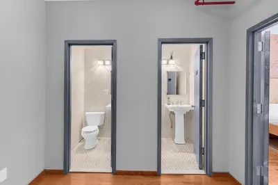 a bathroom with a toilet and a sink at Morris Guest House in Bronx
