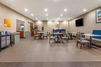 a waiting room with tables and chairs in a store at Comfort Inn Brewster in Brewster