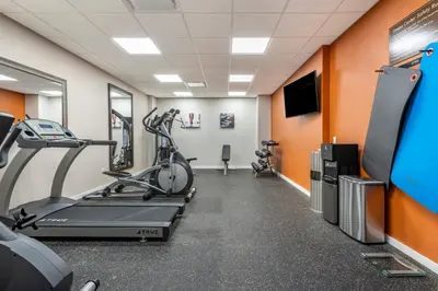 a gym with cardio machines and a flat screen tv at Comfort Inn Brewster in Brewster