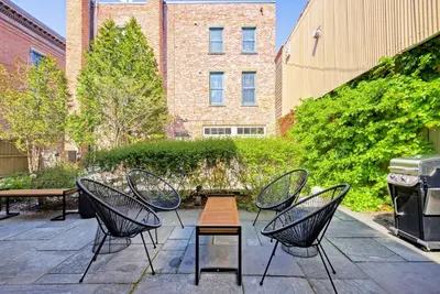 a patio with chairs and a table and a grill at Nautical Nest Hudson in Hudson