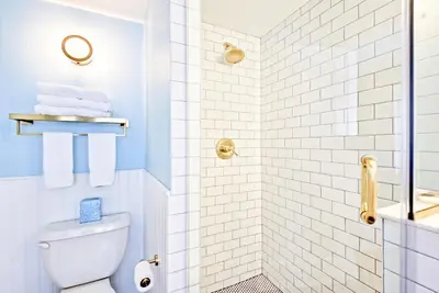 a bathroom with a toilet and a shower at Nautical Nest Hudson in Hudson