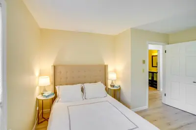 a bedroom with a large white bed with two lamps at Cozy Catskill Condo - 2 Mi to Windham Mountain Ski in Windham