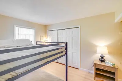 a bedroom with a bed and a lamp and a door at Cozy Catskill Condo - 2 Mi to Windham Mountain Ski in Windham
