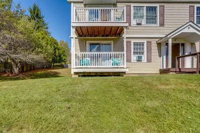 a house with a balcony and a yard at Cozy Catskill Condo - 2 Mi to Windham Mountain Ski in Windham
