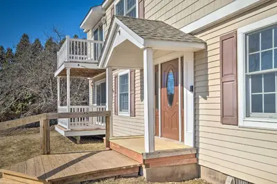 a house with a wooden porch with a door at Cozy Catskill Condo - 2 Mi to Windham Mountain Ski in Windham