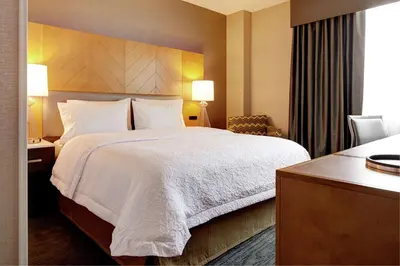 a hotel room with a large bed and a desk at Hampton Inn Brooklyn Downtown in Brooklyn