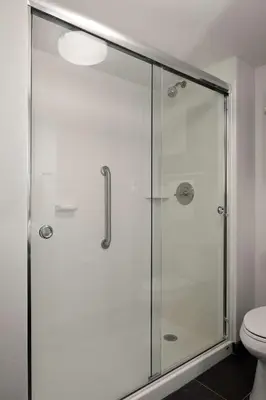 a bathroom with a glass shower with a toilet at Hampton Inn Brooklyn Downtown in Brooklyn