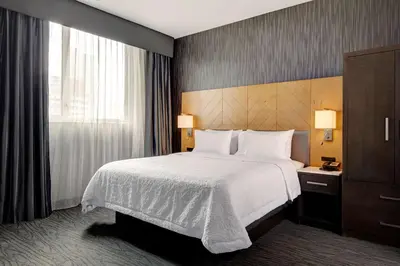 a hotel room with a bed and a window at Hampton Inn Brooklyn Downtown in Brooklyn