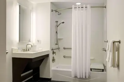 a bathroom with a white shower curtain and a sink at Hampton Inn Brooklyn Downtown in Brooklyn