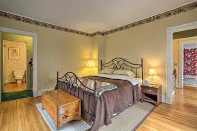 a bedroom with a large bed and a wooden table at Historic House with Record Player, Walk to Downtown! in Roxbury