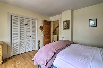 a bedroom with a bed with a pink blanket on it at Historic House with Record Player, Walk to Downtown! in Roxbury