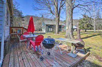 a deck with a grill and a table and chairs at Historic House with Record Player, Walk to Downtown! in Roxbury