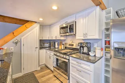 a kitchen with white cabinets and a stove top oven at Woodsy Wilmington Condo 7 Mi to Mount Snow! in Wilmington