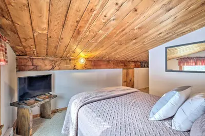 a bedroom with a bed and a wooden ceiling at Woodsy Wilmington Condo 7 Mi to Mount Snow! in Wilmington