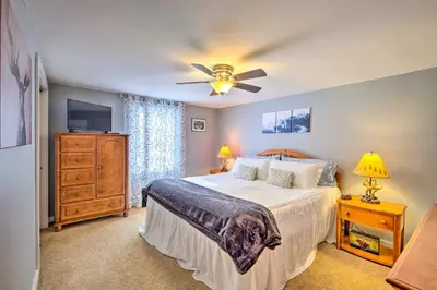 a bedroom with a bed and a ceiling fan at Woodsy Wilmington Condo 7 Mi to Mount Snow! in Wilmington