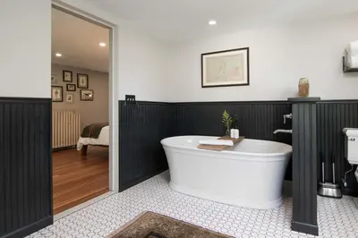 a bathroom with a bath tub in a room at Granville House in Great Barrington