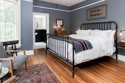 a bedroom with a bed and a living room at Granville House in Great Barrington