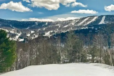 a view of a snowy mountain with trees and snow at The Mountain House Windham Retreat with Hot Tub! in Windham