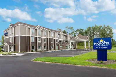 a hotel with a sign in front of a building at Microtel Inn & Suites by Wyndham Amsterdam NY in Amsterdam