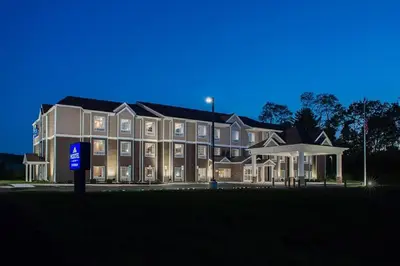 a large building at night with a blue sky at Microtel Inn & Suites by Wyndham Amsterdam NY in Amsterdam