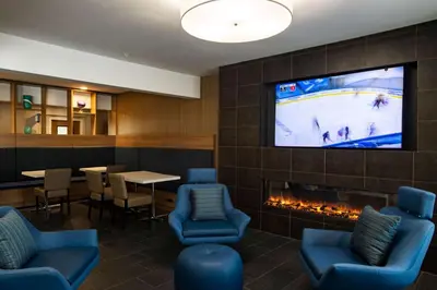a waiting room with a tv and a fireplace at Microtel Inn & Suites by Wyndham Amsterdam NY in Amsterdam