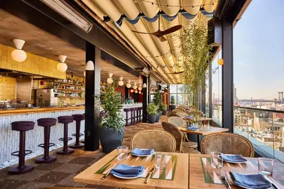 a restaurant with tables and chairs and a bar at The Hoxton, Williamsburg in Brooklyn