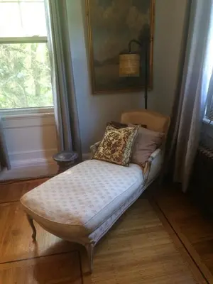 a bed sitting in a room with a window at Gardner Farm Inn in Troy