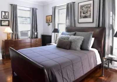 a bedroom with a large bed with a blue blanket at Gardner Farm Inn in Troy