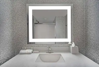 a bathroom with a sink and a mirror at Home2 Suites By Hilton Utica, Ny in Utica